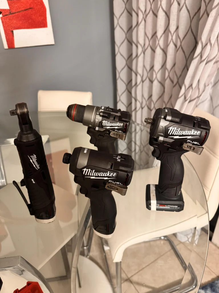 Black Milwaukee power tools and equipment arranged together, showcasing a range of professional tools in a sleek black design.